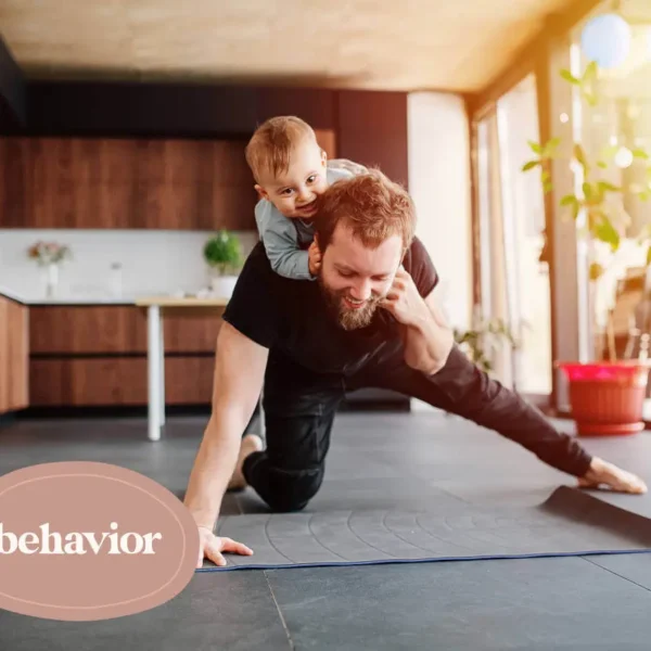 A dad works out with his young child.